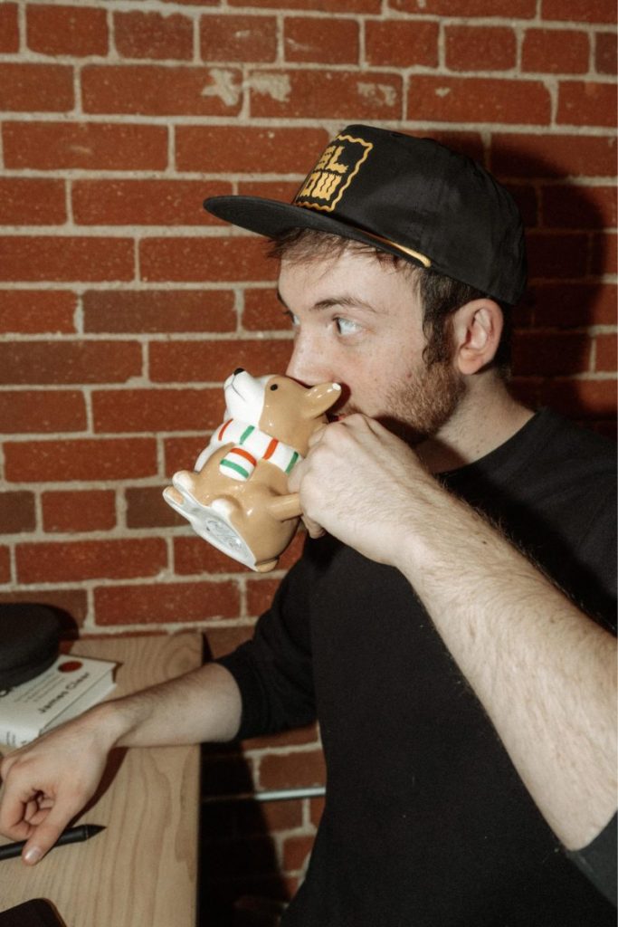 David drinking from corgi mug